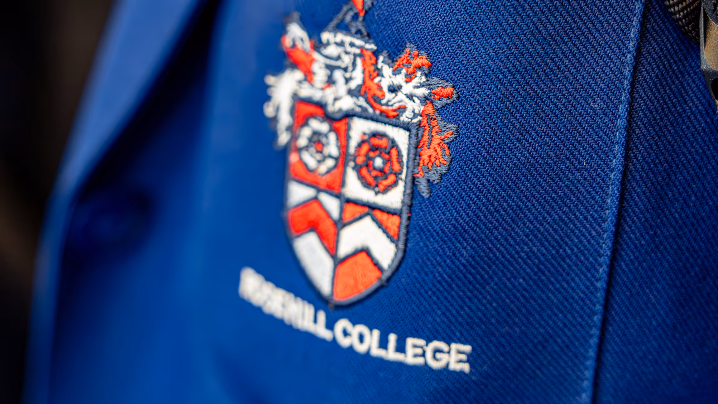 The Rosehill College crest embroidered on a school blazer