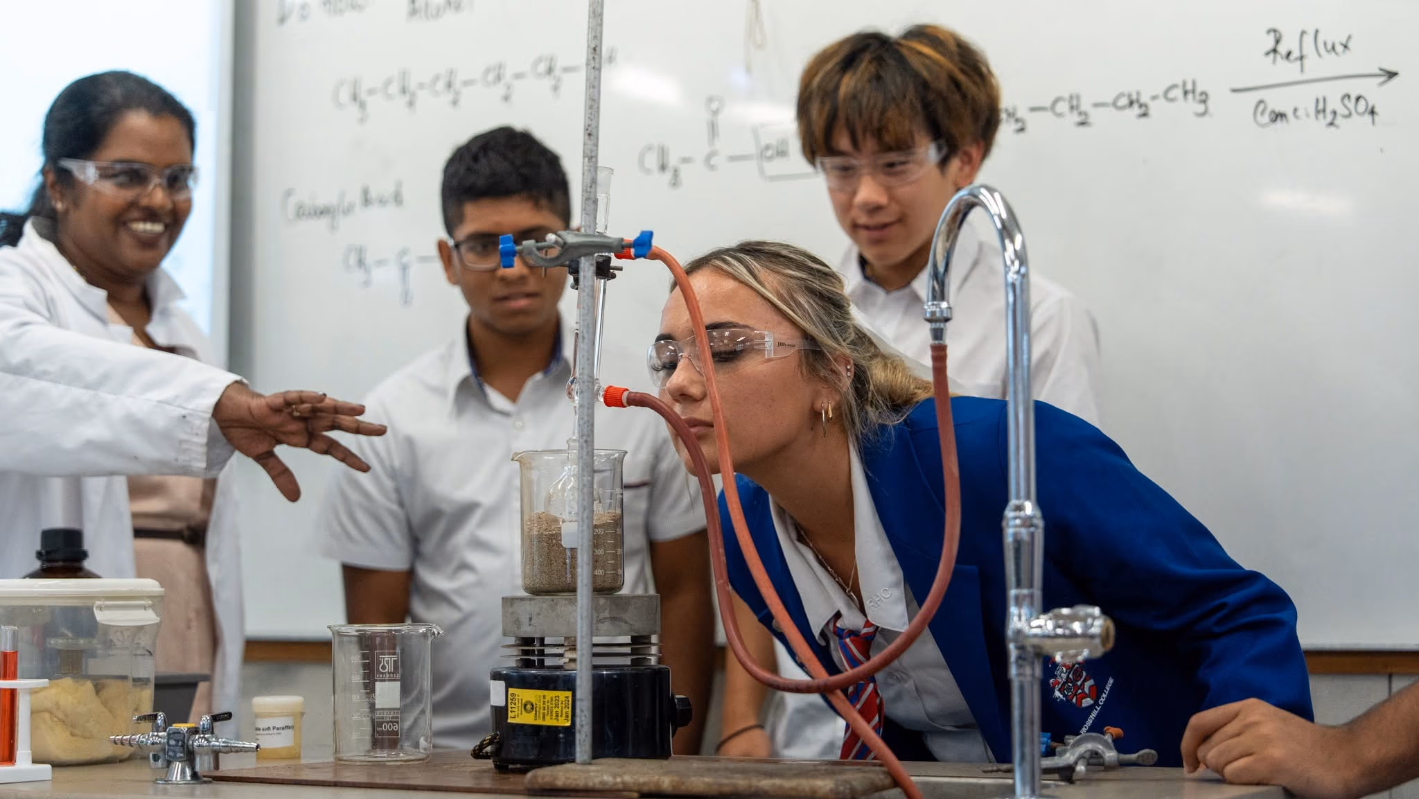 Senior Rosehill College students working with their teacher in a chemistry class